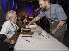 Chef Kellen Crumb serves his winning chowder to Judge Brad Long in the recent Chowder Chowdown in support of Ocean Wise