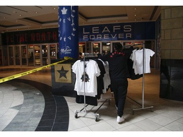 Inside the Scotiabank Arena it was supposed to be game day until the NHL suspended operations - along with other leagues - as the Covid-19 Coronavirus pandemic takes hold throughout the world. (Pictured)Moving merchandise back inside the arena from outside kiosks  in Toronto on Thursday March 12, 2020. Jack Boland/Toronto Sun/Postmedia Network