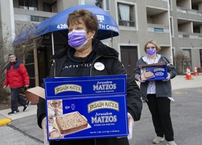Sun Columnist Sue-Ann Levy assists Cheryl Landy, the B’nai Brith Community Program Manager, and other volunteers with the emergency food drive as they bring food and supplies to the community on Thursday, March 26, 2020. (Stan Behal/Toronto Sun/Postmedia Network)