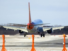 A Sunwing jet lands at London International airport.
