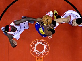 Jun 10, 2019; Toronto, Ontario, CAN; Golden State Warriors center Kevon Looney (5) shoots the ball against Toronto Raptors forward Pascal Siakam (43) and guard Danny Green (14) in game five of the 2019 NBA Finals at Scotiabank Arena. Mandatory Credit: Nathan Denette/Pool Photo via USA TODAY Sports ORG XMIT: USATSI-404669