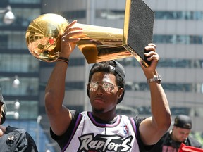 Raptors guard Kyle Lowry shows off the Larry O'Brien trophy to fans during a parade through downtown Toronto last summer to celebrate their NBA title. (Dan Hamilton/USA TODAY Sports)