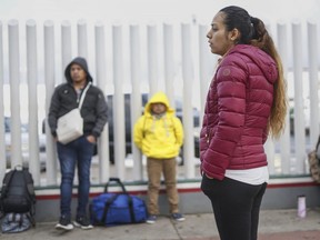 Honduran migrants wait in line to plead their asylum cases at the El Caparrel border crossing in Tijuana, Mexico, on Monday, March 2, 2020.