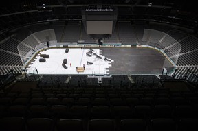Crews cover the ice at American Airlines Center in Dallas, home of the Dallas Stars, after the NHL season was put on hold due to coronavirus threats. (The Associated Press)