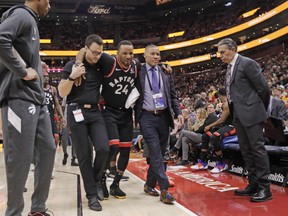 Raptors guard Norman Powell is helped to the locker-room after being injured in the first half against the Utah Jazz on Monday. (Rick Bowmer/The Associated Press)