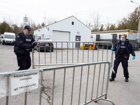 (RCMP officers secure the facility at the New York into Canada border crossing, at Roxham Road, in Hemmingford, Quebec, Canada on March 19, 2020.
