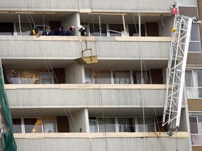 Investigators examine the scene at 2757 Kipling Ave., in Rexdale, where four workers died on Christmas Eve 2009 in a scaffolding collapse. (Toronto Sun files)