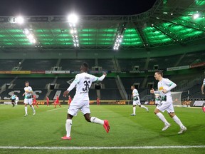 Borussia Moenchengladbach's Breel Embolo celebrates scoring their first goal with Stefan Lainer and teammates during the match being played behind closed doors on March 11, 2020, while the number of coronavirus cases grow around the world.
