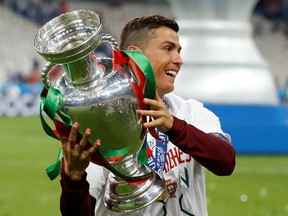 Portugal's Cristiano Ronaldo celebrates with the trophy after winning Euro 2016 at the State de France in Saint-Denis, Paris on July 7, 2016.