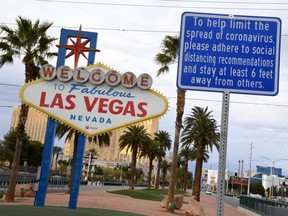 A message on a sign placed in front of the Welcome to Fabulous Las Vegas sign, where tourists often line up to take photos, displays a message about social distancing due to the continuing spread of the coronavirus across the United States on March 22, 2020 in Las Vegas, Nevada. On Friday, Nevada Gov. Steve Sisolak ordered a mandatory shutdown of most nonessential businesses in the state until April 16 to help combat the spread of the virus. The World Health Organization declared the coronavirus (COVID-19) a global pandemic on March 11th.  (ETHAN MILLER/Getty Images)