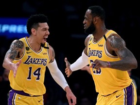 The postponed game between the Los Angeles Lakers and Toronto Raptors, which had been scheduled for Tues. March 24, would have been the only visit by LeBron James (right) to Toronto in the regular season. It also would have featured a championship ring ceremony for former Raptor Danny Green (left). (HARRY HOW/Getty Images)