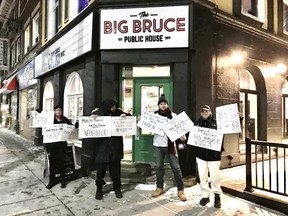 A group of former employees of The Big Bruce Public House hold a protest for wages owed to them by bar owner Norm Tumak in December 2019. FACEBOOK