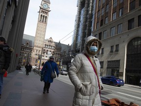 At King & Bay Streets in the heart of Canada's business centre, Torontonians adjust to the new normal as businesses close,  or ask their employees to work  from home,  on Monday March 16, 2020. Stan Behal/Toronto Sun/Postmedia Network
