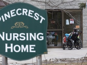 A resident waits for staff to let her into the Pinecrest Nursing Home in Bobcaygeo Saturday March 28, 2020. Stan Behal/Toronto Sun
