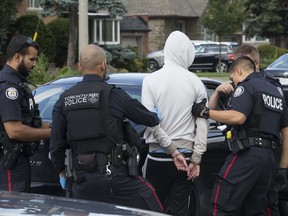 Toronto Police execute a high risk take-down on O''Connor Drive and guns were confiscated on Friday afternoon only hours after 2 men were shot , one killed in the nearby Parma Court area of East York, on Friday August 9, 2019. Stan Behal/Toronto Sun/Postmedia Network
