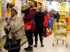 Shoppers fill the stores, and emptying shelves, stocking up on supplies in the wake of the Coronavirus outbreak in Toronto on Friday March 13, 2020. Dave Abel/Toronto Sun/Postmedia Network