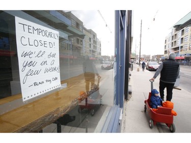 Storefronts along Kingston Rd. near Beech Ave. like Black Dog Cafe have signage about their closures on Thursday March 26, 2020. Jack Boland/Toronto Sun/Postmedia Network