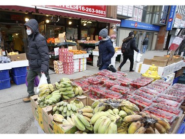 Business as usual at curbside stores and fresh produce markets along Spadina Ave. in the Chinatown area  on Thursday March 26, 2020. Jack Boland/Toronto Sun/Postmedia Network