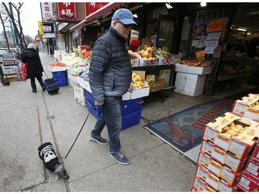 Barry Radun and his blue and brown Daschund Shuggie were out shooting for food at the fresh produce markets along Spadina Ave. in the Chinatown area  on Thursday March 26, 2020. Jack Boland/Toronto Sun/Postmedia Network