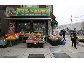 Grocery and plant shopping along curbside markets on College St. W. and Montrose Ave. in Little Italy on Thursday March 26, 2020.