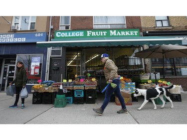 Grocery and plant shopping along curbside markets on College St. W. and Montrose Ave.  in the Little Italy areaon Thursday March 26, 2020. Jack Boland/Toronto Sun/Postmedia Network