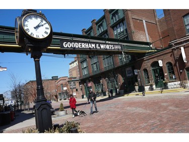 People enjoy the sunny weather at the Gooderham and Worts Distillery District. There was a brisk wind and the temperature got up to 10C by mid afternoon on Friday March 27, 2020. Jack Boland/Toronto Sun/Postmedia Network