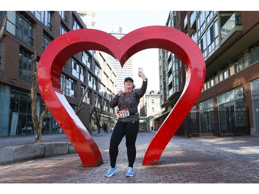 Angela Spierenburg takes a break for a selfie at the Love Sign in the Gooderham and Worts Distillery District while doing the Virtual Chilly half marathon 21.1 kms - and recording it because marathons have been cancelled because of COVID-19 on Friday March 27, 2020. Jack Boland/Toronto Sun/Postmedia Network