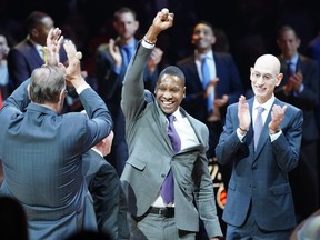 Raptors president Masai Ujiri (centre) celebrates getting his NBA championship ring before a game at Scotiabank Arena this season, which is on hiatus due to the coronavirus. (John E. Sokolowski/USA TODAY Sports)