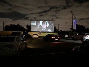 People inside their cars watch a movie at a drive-in theatre while keeping social distancing following the outbreak of the coronavirus disease (COVID-19) in Fort Lauderdale, Florida, U.S., March 28, 2020. Marco Bello/REUTERS