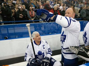 Wendel Clark and Rick Vaive (seated) play for the Toronto Maple Leafs in an alumni game. Vaive holds the franchise mark for goals with 54. (Jack Boland/Toronto Sun)