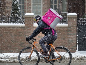 A Foodora delivery cyclist on a street in Toronto, Wednesday February 7, 2018. (Photo Peter J. Thompson for for Financial Post)