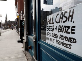 A sign is pictured on a restaurant window in a normally busy area as efforts continue to help slow the spread of coronavirus disease (COVID-19), in Ottawa, March 28, 2020.  (REUTERS/Blair Gable)