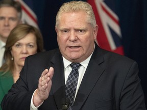 Ontario Premier Doug Ford answers questions as Health Minister Christine Elliott and Finance Minister Rod Phillips listen at Queen's Park in Toronto on Monday, March 23, 2020. (THE CANADIAN PRESS)
