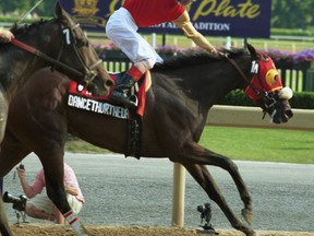 Jockey Gary Boulanger rides the filly Dancethruthedawn to capture the $1,000,000 Queen's Plate at Woodbine in 2001. (SUN FILES)