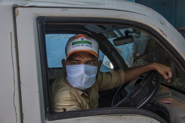 NEW DELHI, INDIA - APRIL 08: An Indian municipal employee covering his face with a protective mask unloads waste from his vehicle at a dumping site, as India remains under an unprecedented lockdown over the highly contagious coronavirus (COVID-19) on April 08, 2020 in New Delhi, India. As India remains under an unprecedented lockdown the number of Covid-19 cases has crossed the 5000 mark with 164 deaths and the provincial governments have identified over 30 hotspots. Most reports say as the 21-day lockdown ends on April 14, the Narendra Modi government will keep these hotspots under stringent restrictions and ramp up the testing. India ranks extremely low in the coronavirus-hit countries list based on the number of tests done per million population. India has reported less than 5,300 infected cases and 130,000 tests so far. (Photo by Yawar Nazir/Getty Images)