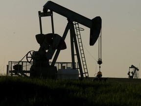 Pumpjacks spin on a field on Tuesday June 9, 2015 west of Sexsmith, Alta.