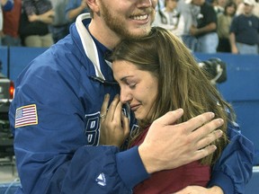 Hall of Fame pitcher Roy Halladay embraces his wife, Brandy, after winning his club-record 22nd game of the season during his days with the Toronto Blue Jays.