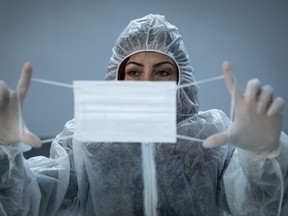 A worker inspects a newly made surgical face mask in Istanbul, Turkey.