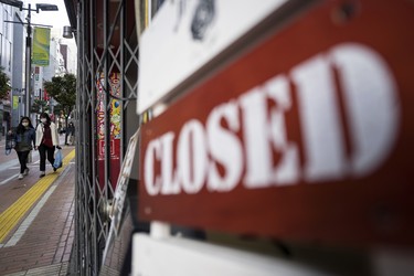 TOKYO, JAPAN - APRIL 08: Women walk near a closed sign outside a restaurant on April 08, 2020 in Tokyo, Japan. Japan's Prime Minister Shinzo Abe yesterday declared a state of emergency that will cover 7 of Japans 47 prefectures, including Tokyo and Osaka, as the Covid-19 coronavirus outbreak continues to spread in the country. The move will allow affected prefectures to take measures including expropriating private land and buildings and requisitioning medical supplies and food from companies that refuse to sell them. Tokyo recorded 144 new infections on Wednesday bringing the total in the capital to 1,339 with 85 deaths nationwide.   (Photo by Tomohiro Ohsumi/Getty Images)