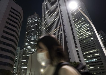 TOKYO, JAPAN - APRIL 08: A woman walks past buildings in the Shinjuku district at night on April 08, 2020 in Tokyo, Japan. Japan's Prime Minister Shinzo Abe yesterday declared a state of emergency that will cover 7 of Japans 47 prefectures, including Tokyo and Osaka, as the Covid-19 coronavirus outbreak continues to spread in the country. The move will allow affected prefectures to take measures including expropriating private land and buildings and requisitioning medical supplies and food from companies that refuse to sell them. Tokyo recorded 144 new infections on Wednesday bringing the total in the capital to 1,339 with 85 deaths nationwide.   (Photo by Tomohiro Ohsumi/Getty Images)