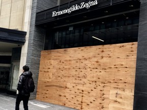 High-end stores board up along Bloor St. on  April 3, 2020. (Veronica Henri, Toronto Sun)
