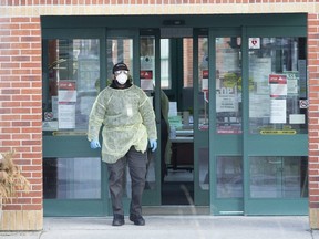 A staff member exits Seven Oaks Long-Term Care Home in Toronto.