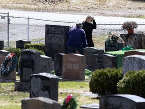 Family members grieve a victim of Covid-19 at Verulam Cemetery on the outskirts of Bobcaygeon on April 6, 2020. (Toronto Sun photo)