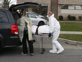 A body is removed from the Eatonville Care Centre long-term facility in Etobicoke which has experienced a COVID-19 outbreak.