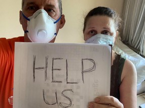 Off the shore of Panama, Canadian passengers, Chris and Anna Joiner, ask for help onboard the MS Zaandam, Holland America Line cruise ship, on March 27, 2020. (Chris Joiner/Handout via REUTERS)