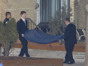 Wolfgang Droege’s body is removed from his Scarborough apartment building in 2005. TORONTO SUN