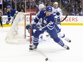 Toronto Maple Leafs centre Auston Matthews (34) is hooked by Tampa Bay Lightning centre Barclay Goodrow (19) during first period NHL hockey action in Toronto on Tuesday March 10, 2020. THE CANADIAN PRESS/Chris Young