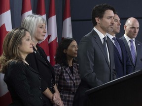 Prime Minister Justin Trudeau listens to a question with Deputy Prime Minister and Minister of Intergovernmental Affairs Chrystia Freeland, Minister of Health Patty Hajdu, Chief Medical Officer Theresa Tam, Minister of Finance Bill Morneau and President of the Treasury Board Jean-Yves Duclos during a news conference on the coronavirus situation, in Ottawa, Wednesday March 11, 2020. THE CANADIAN PRESS/Adrian Wyld