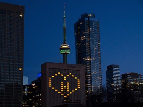 Lights in the rooms of the Hilton Hotel in Toronto are lit to honour front line health care workers on Sunday April 5, 2020.