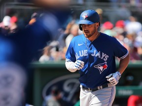 Toronto Blue Jays first haseman Travis Shaw (6) scores after hitting a home run against the Boston Red Sox at Spring Training in March.